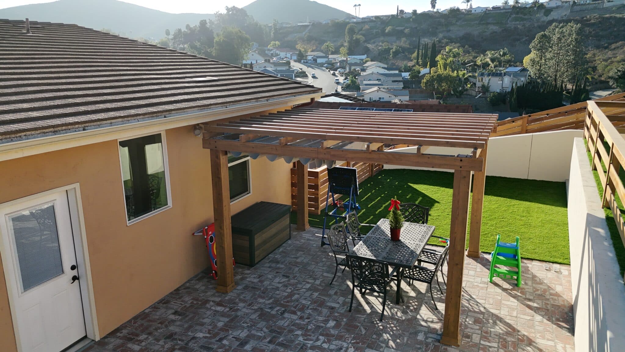 Spacious outdoor lounge area with privacy fence, concrete patio, and modern seating in San Diego.