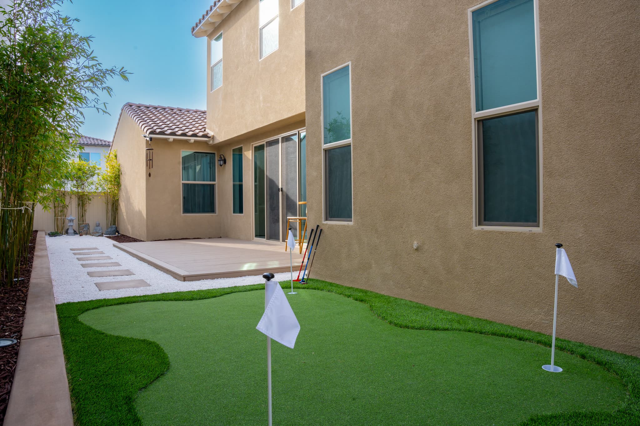 Backyard transformation in Chula Vista with a custom putting green and artificial grass.