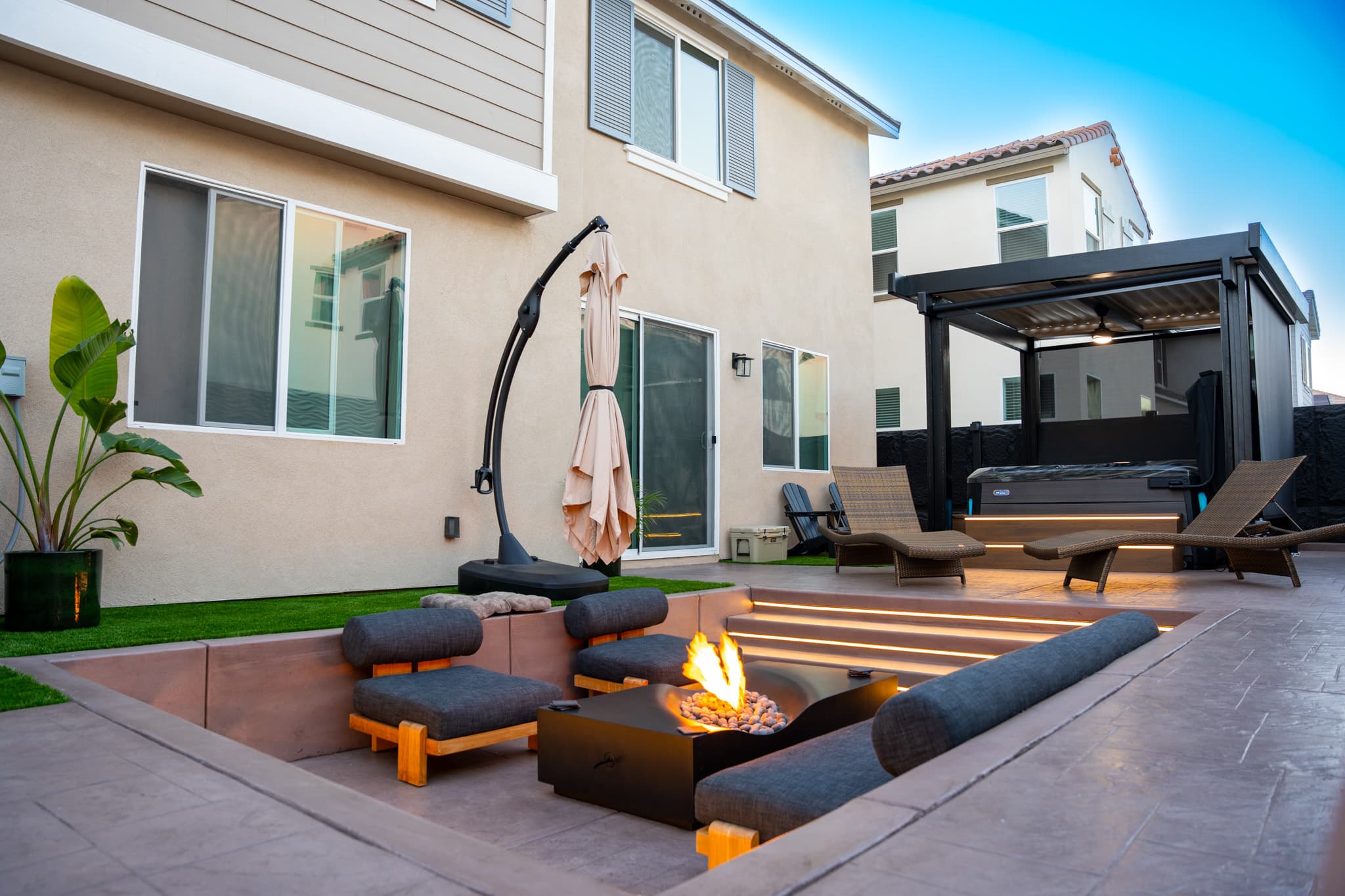 backyard design with fire pit, lounging area, jacuzzi, etc.