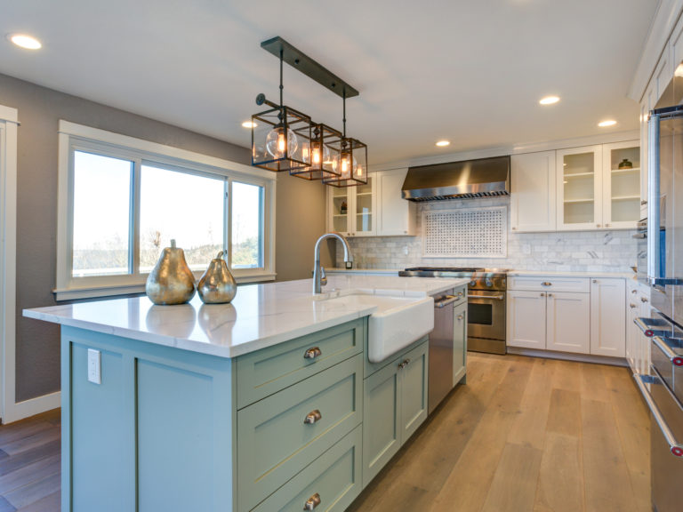 Lime green kitchen island with pendant lighting above