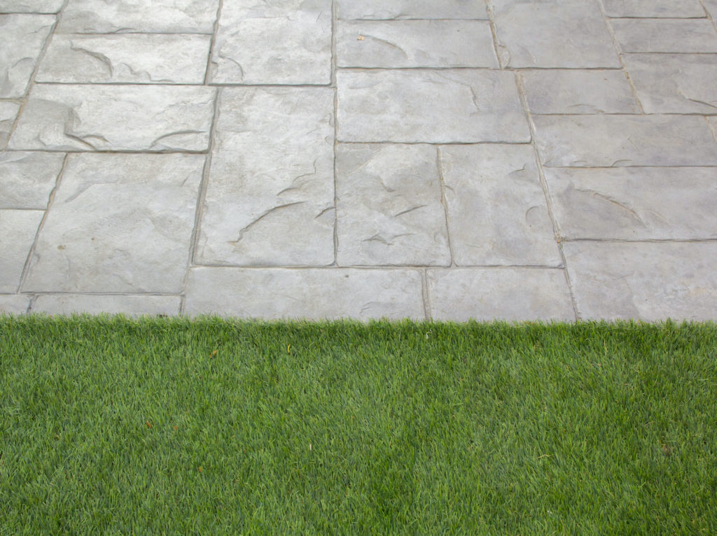 Stamped Concrete next to artificial turf