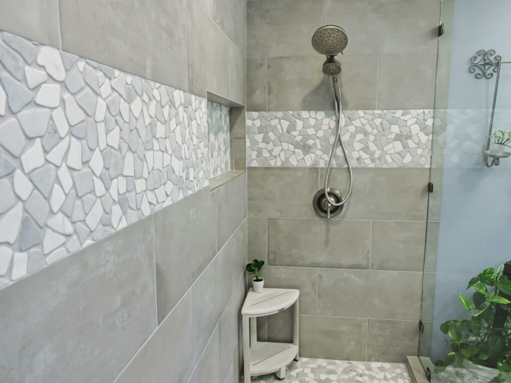 Shower with Glass Sliding Doors Pebbled and Grey Tile 2