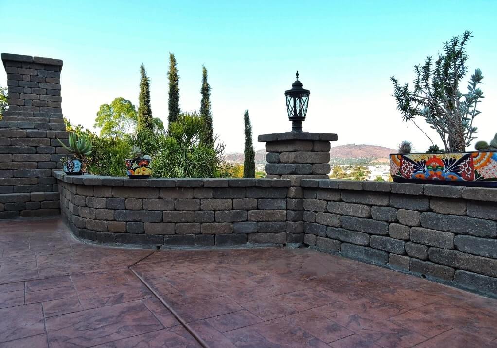 fireplace with stamped concrete and custom garden wall