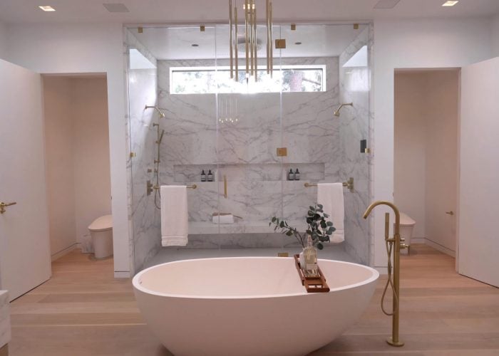 Bathroom with Marble Tile, Wood Flooring, Standing Tub, Gold Fixtures